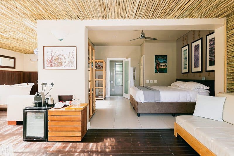 Camps Bay Retreat: Wooden hot tub on patio with dining table, open bedroom doors